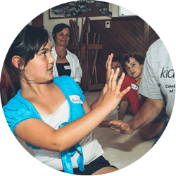 A school child creating a boundary with her hands and saying NO