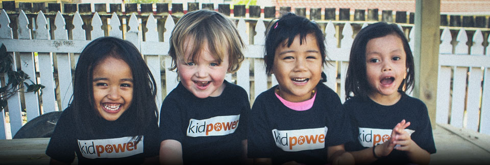 Four preschoolers wearing Kidpower shirts and laughing