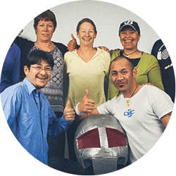 A group of adults with a suited Fullpower instructor giving the thumbs up