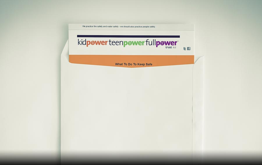 An envelope with a Kidpower newsletter sticking out of the top