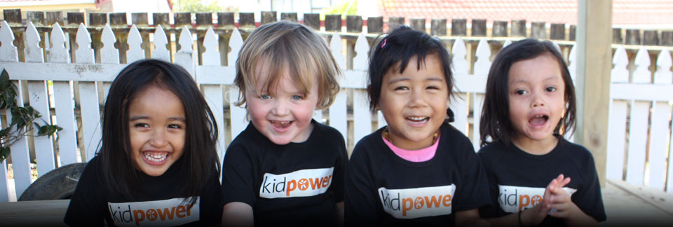 Four preschoolers wearing Kidpower shirts and laughing